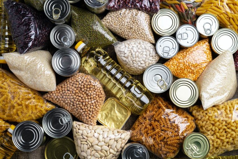 Donations food with canned food on the table background. Donate concept.
